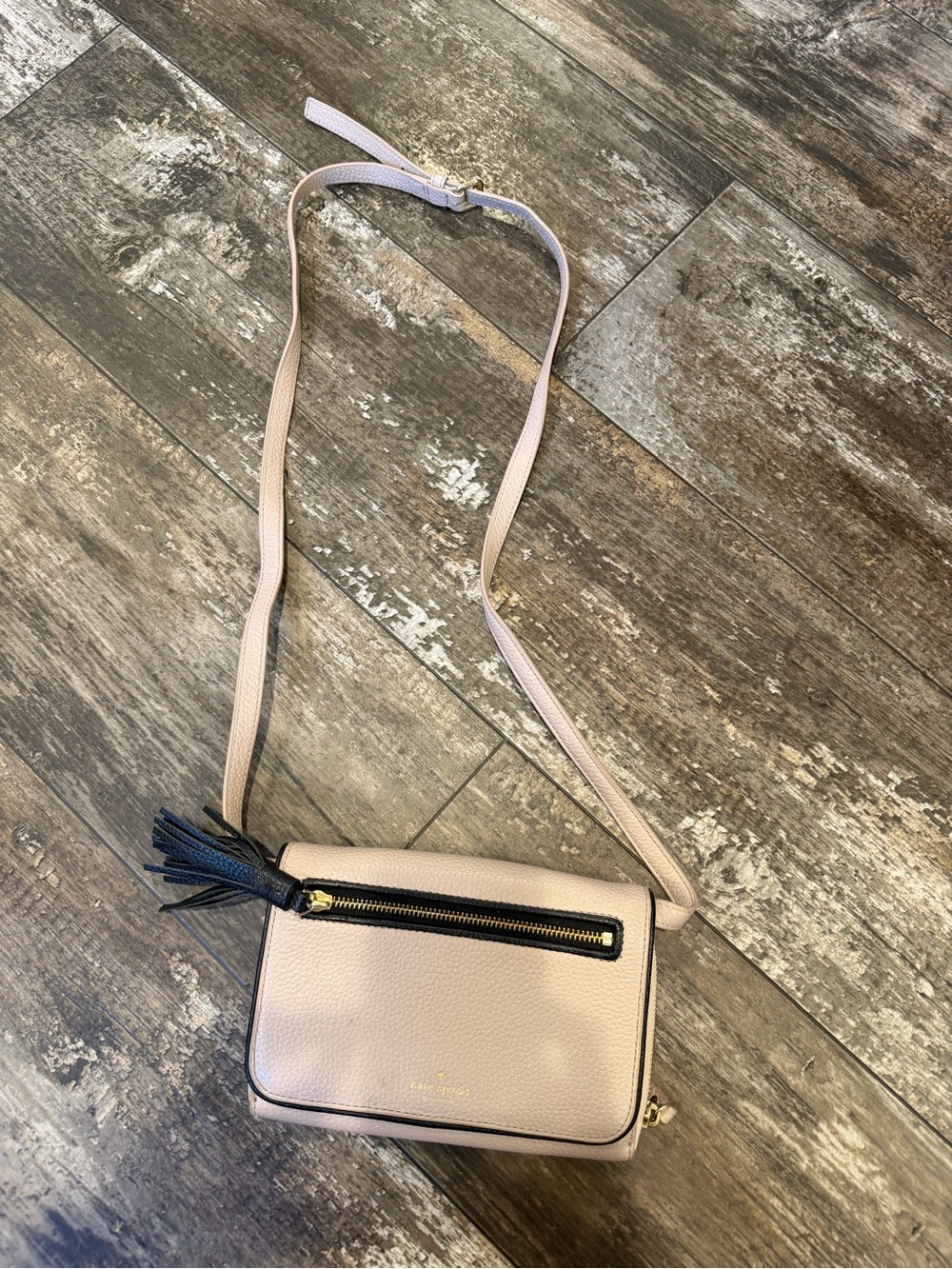 kate spade blush pink crossbody with black tassel and gold hardware